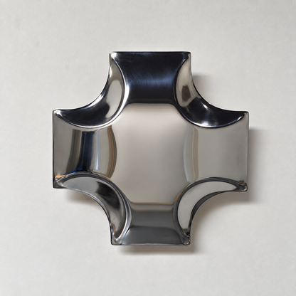 Quadra Wall Sculpture — mirror-finish stainless steel quatrefoil cross wall decor by AERIS LIVING